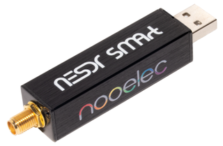 The Nooelec NESDR SMArt v5: a black aluminium USB dongle with an SMA antenna connector at one end